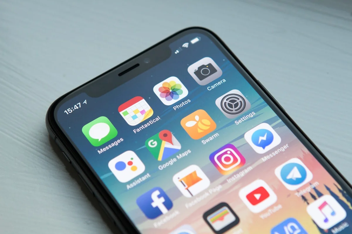 A person absorbed in their smartphone screen — eyes, not mouth, engaged with the phone.