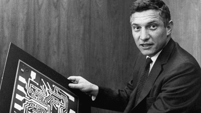 Robert Noyce with early integrated circuit motherboard