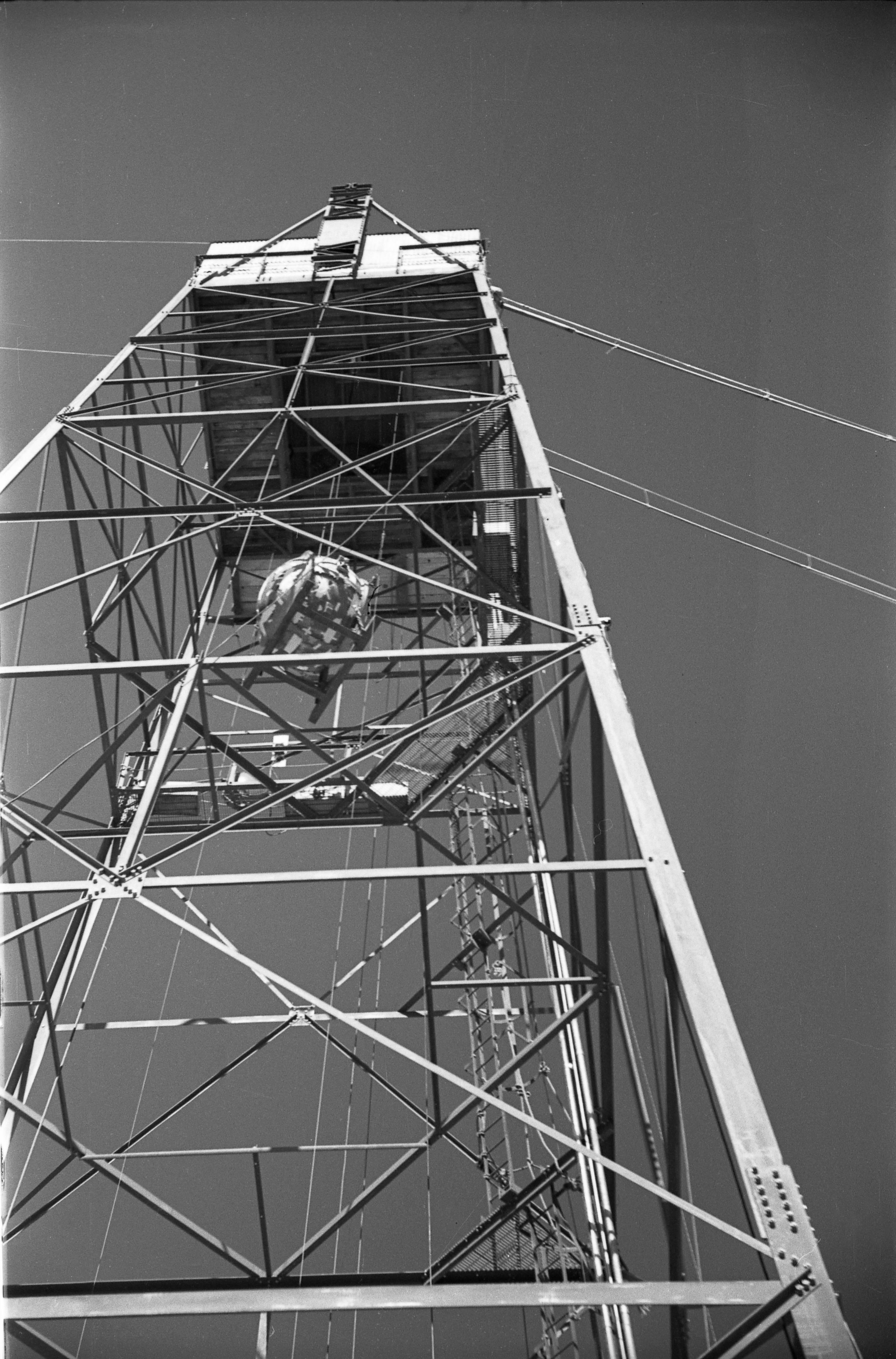 The Gadget being hoisted to the top of the Trinity tower, suspended at 100 feet